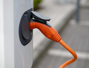 Wall Mural - Close-up photo of an electric car charger with a blurry background