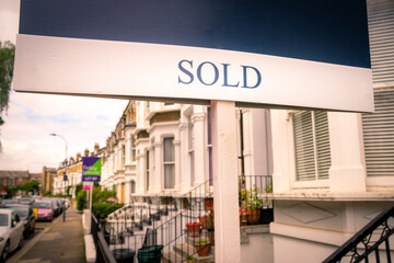 Wall Mural - Estate agent SOLD sign on street of terraced houses