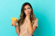 © luismolinero - Young woman holding fried chips over isolated background having doubts and thinking
