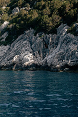 Wall Mural - view of the rocky coastline from a boat on the sea