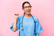 Young nurse Colombian woman isolated on pink background intending to realizes the solution while lifting a finger up