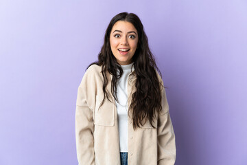 Wall Mural - Young caucasian woman isolated on purple background with surprise facial expression