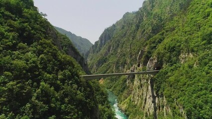 Wall Mural - Aerial video. Shooting a beautiful gleby gorge and bridge on a sunny summer day