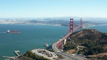 Aerial shot of Golden Gate Bridge and boat and car traffic in  San Francisco Bay