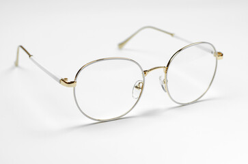 Wall Mural - Stylish eyeglasses on a white background. Iron frame glasses