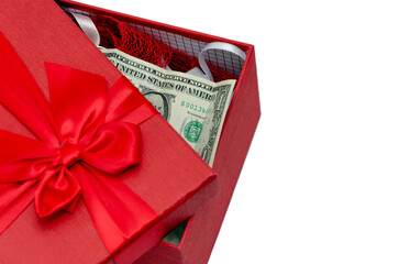 Red gift box with a bow and dollar banknote. Isolated on а white background