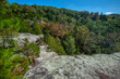 Autumn colors from atop a stone mountain landscape.