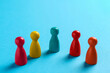 © New Africa - Colorful pawns on light blue background, closeup. Social inclusion concept