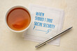 © MarekPhotoDesign.com - When should I take social security? Retirement and finance planning question, handwriting on napkin with tea.