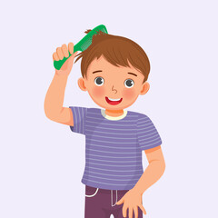 cute little boy holding comb enjoying combing his hair 