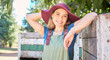 © Jade M/peopleimages.com - Portrait of a female farmer standing under a tree next to a rustic wooden crate on a organic and sustainable farm. One young happy woman smiling outside in an orchard on a sunny day picking apples