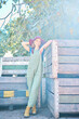 © Jade M/peopleimages.com - Portrait of a female farmer standing near crates on a fruit farm during harvest season. Farm worker standing in an orchard next to wooden storage containers and apple trees on bright sunny day