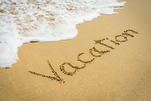 Word Vacation On The Beach Sand - Vacation And Travel Concept