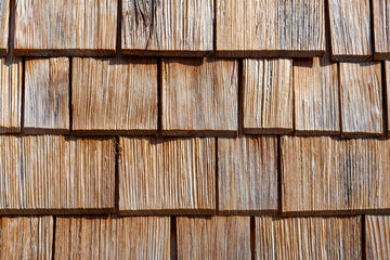 Wooden shingles, facade cladding of wooden shingles on a house in the Austrian Alps. Copy space for your design. Web banner. 
