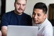 © Austockphoto - happy gay couple using computer