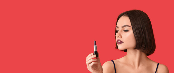 Wall Mural - Beautiful young woman holding lipstick on red background with space for text