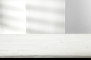 Wall Mural - white wooden table and wall with shadows.