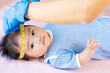 asian doctor measure baby head