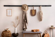 © FollowTheFlow - The stylish composition of cosy entryway with wooden basket, carpet, hanger and personal accessories. Beige wall. Home decor. Template.
