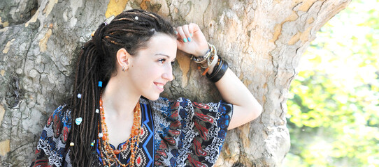 Joyful young woman profile portrait with dreadlocks