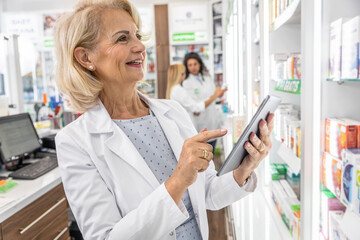 Senior female pharmacist working in pharmacy.