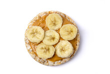 Isolated Rice Cake With Peanut Butter And Banana Slice On White Background