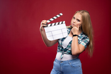 Wall Mural - Young blonde model holding a blank movie filming clapper board