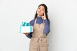 © luismolinero - Pastry Russian chef holding a big cake isolated on white background thinking an idea
