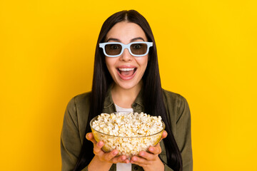 Wall Mural - Photo of impressed millennial lady watch movie wear shirt eyewear isolated on yellow background