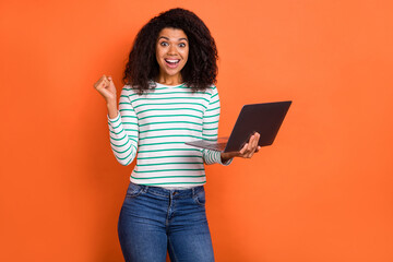 Wall Mural - Photo of hooray millennial volume hairdo lady hold laptop yell wear shirt jeans isolated on orange color background