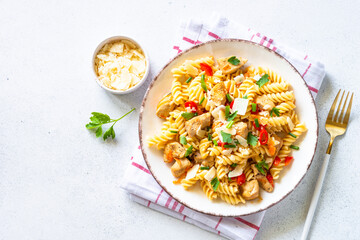 Canvas Print - Pasta with turkey or chicken, vegetables and parmesan at white table. Top view with copy space.