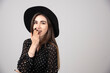 © rastockinc - Stylish woman with black hat smiling happily