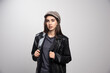 © rastockinc - Young woman wearing black leather jacket and cap