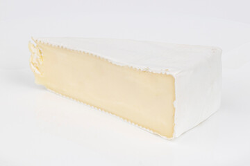 Soft brie cheese on a white background, a piece of dairy delicacy.