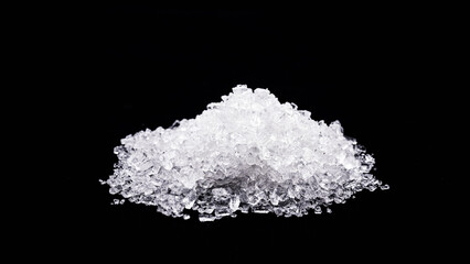 sodium chloride, known as salt or table salt, an important food preservative and a popular seasoning, isolated on black background