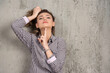 © rastockinc - A young pretty woman holding hair in ponytail