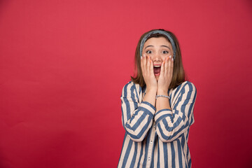 Wall Mural - Beautiful girl covering mouth with both of hands and screaming