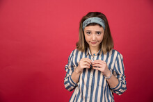 Female Teenager In Striped Shirt Looking Capricious