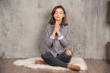© azerbaijan-stockers - Young woman sitting with closed eyes in the prayer position