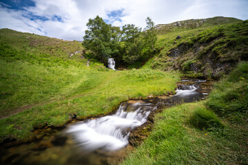 Wall Mural - long exposure view of the Ardvreck Castle Waterfall on Loch Assynt in the Scottish Highlands