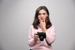 © rastockinc - Female photographer holding camera and thinking
