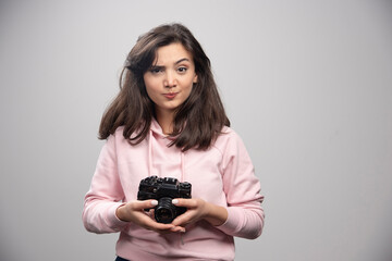 Wall Mural - Beautiful woman in pink sweatshirt posing with camera