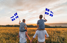 Patriotic Family Waving Quebec Flags On Sunset