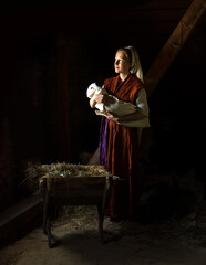 Canvas Print - Mary in the stable near the manger with the baby