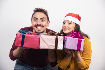 Wall Mural - Young man with woman posing with Christmas presents