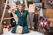 © rastockinc - Woman sitting on the floor at home with Christmas presents