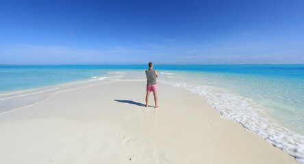 Sticker - one man on a tropical island with white sand in the ocean