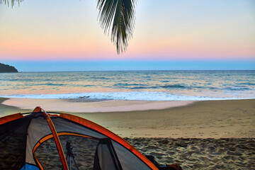 Wall Mural - camping tent in front of the beach at sunrise with beautiful colors sand and plam tree in first plane on sayulita beach 