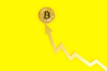 Arrow graph indicates growth of value bitcoin cryptocurrency,on yellow background.