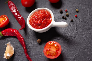 Poster - Chilly pepper and tomato sauce ingredient for homemade cooking at table